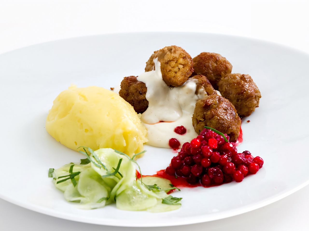 Meatballs with Lingonberry Sauce, Pickled Cucumber, and Brown Gravy