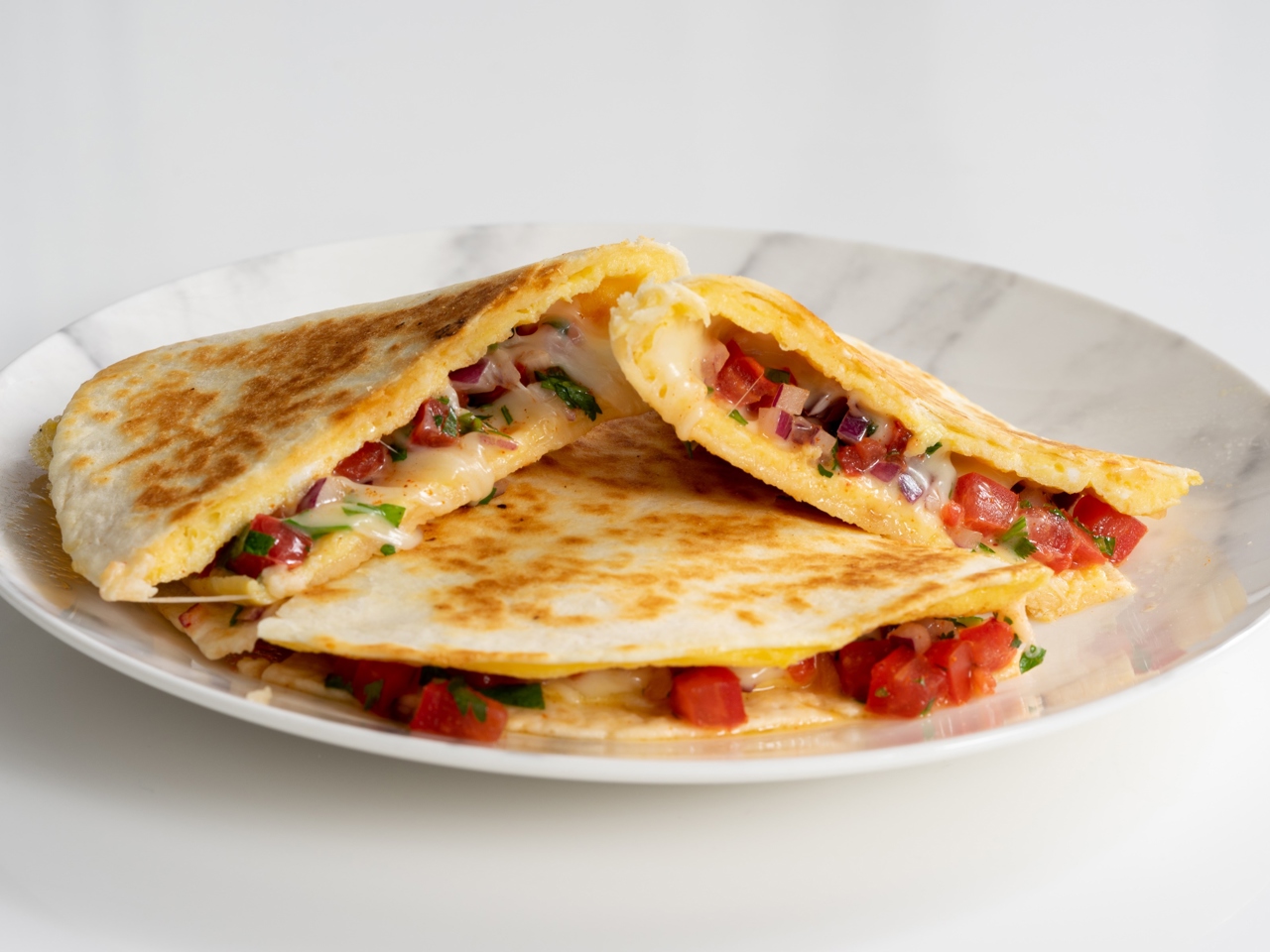 Breakfast Sandwich with Omelette, Tomatoes, and Cheese