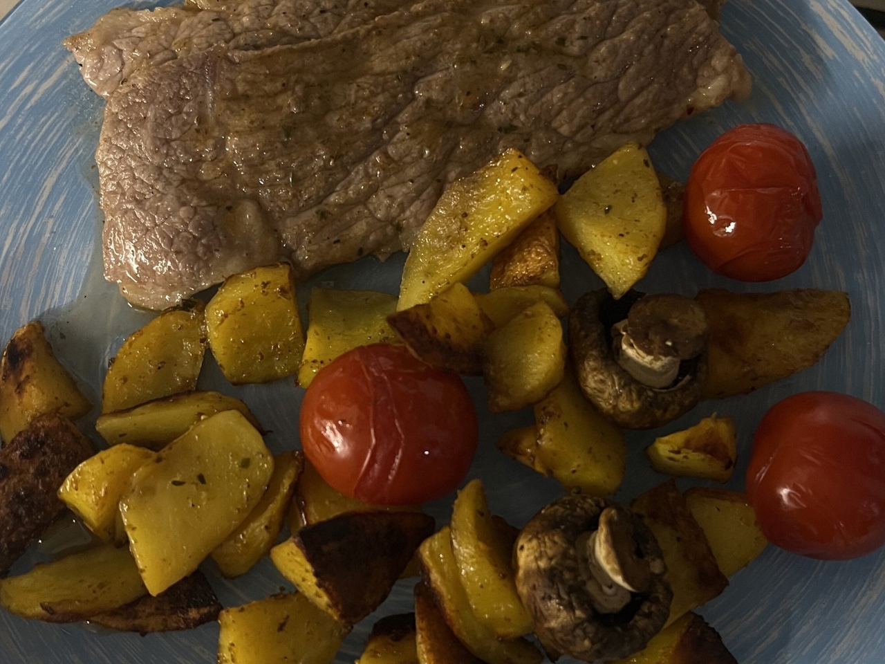 Steaks with Baked Potato Wedges, Cherry Tomatoes, and Mushrooms
